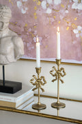 S 2 Gold Cast Iron Candle Holders With Playful Bow Design